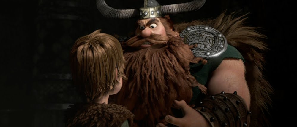 Hiccup (Jay Baruchel) in the shadow of his father, Stoick the Vast (Gerard Butler)