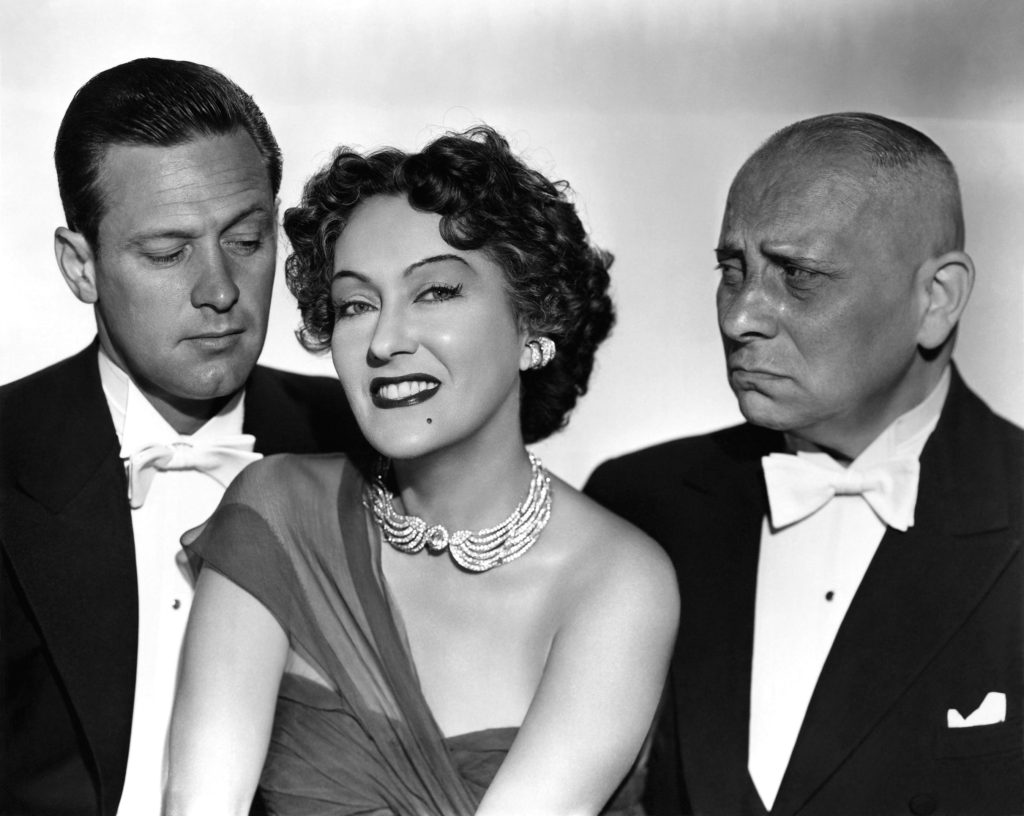 L to R: William Holden as Joe Gillis, Gloria Swanson as Norma Desmond, and Erich von Stroheim as Max von Mayerling