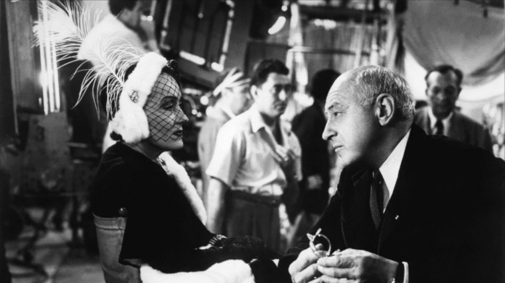 Cecil B. DeMille (playing himself) reunites with his former silent-era starlet