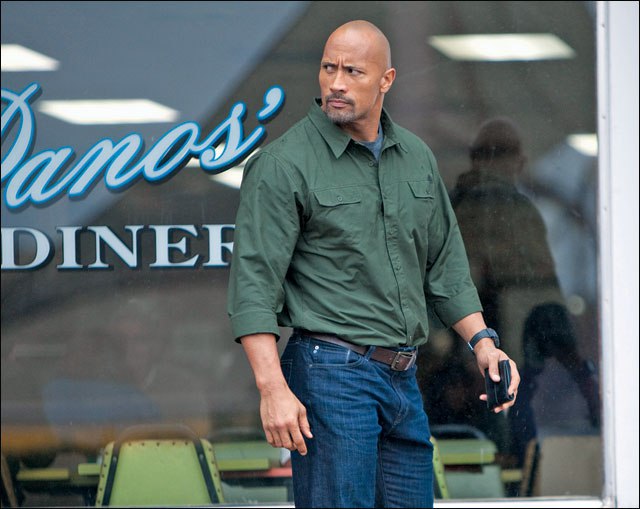 The Rock smells what the diner is cooking.
