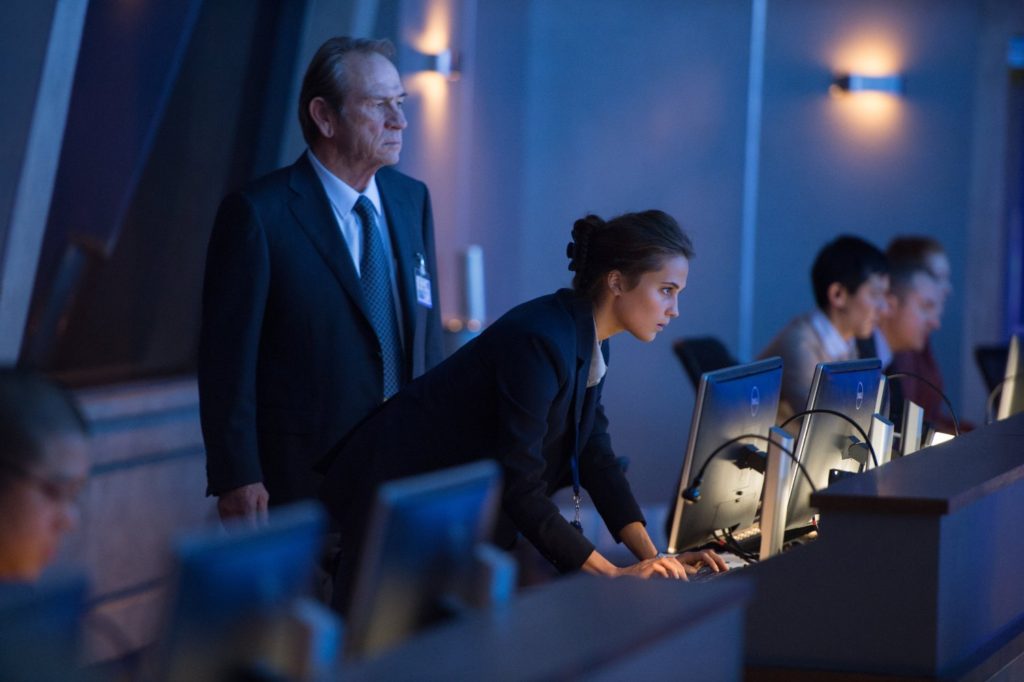 Tony Lee Jones and Alicia Vikander work the control room in JASON BOURNE.