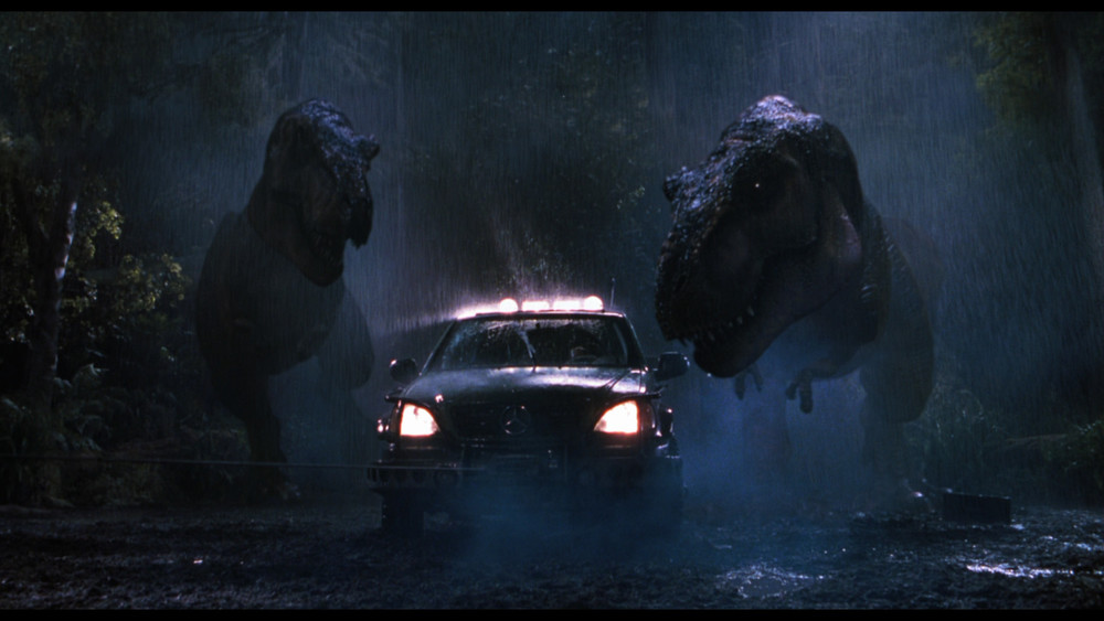 Two T-Rexes chase down a car in THE LOST WORLD: JURASSIC PARK (1997)