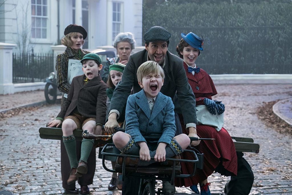 Emily Mortimer, Nathanael Saleh, Pixie Davies, Julie Walters, Lin-Manuel Miranda, Jack Dawson, and Emily Blunt ride a bike in MARY POPPINS RETURNS (2018)