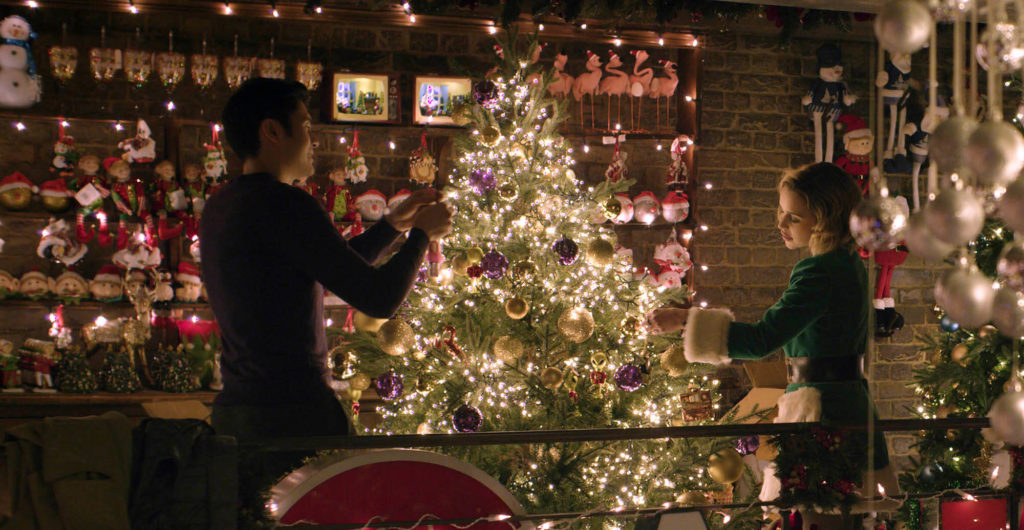 Emilia Clarke and Henry Golding trim a tree in LAST CHRISTMAS (2019)