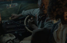 Iyana Halley, Idris Elba, and Leah Jeffries hide from a lion inside their vehicle in BEAST (2022)