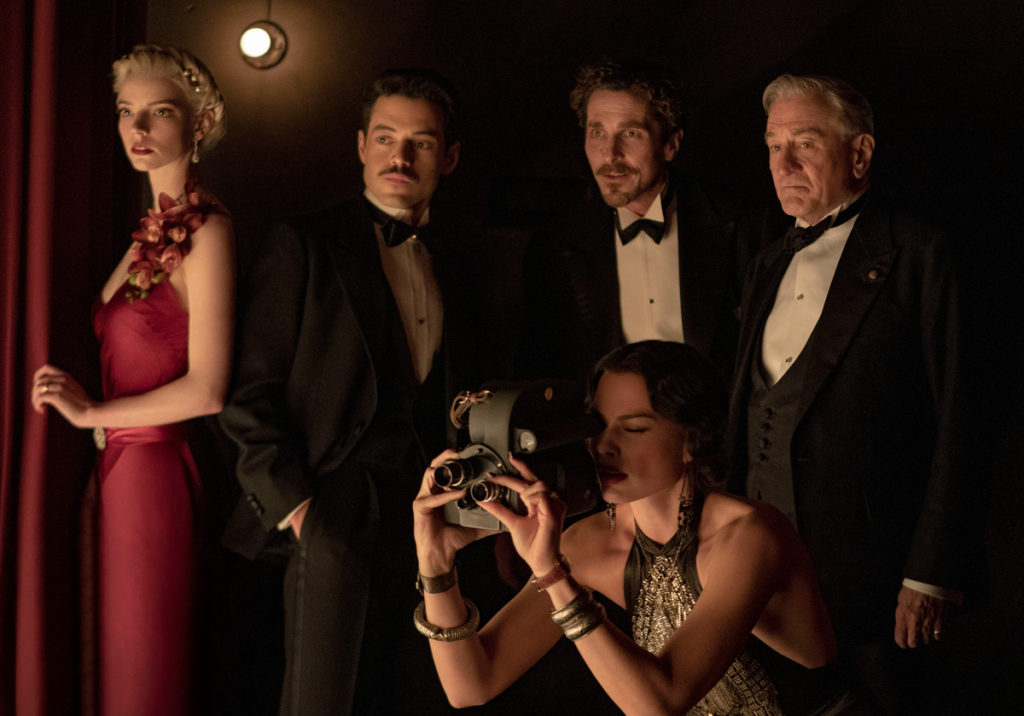 (L-R): Anya Taylor-Joy as Libby, Rami Malek as Tom, Christian Bale as Burt, Robert De Niro as Gil, and Margot Robbie as Valerie in 20th Century Studios' AMSTERDAM. Photo by Merie Weismiller Wallace; SMPSP. © 2022 20th Century Studios. All Rights Reserved.