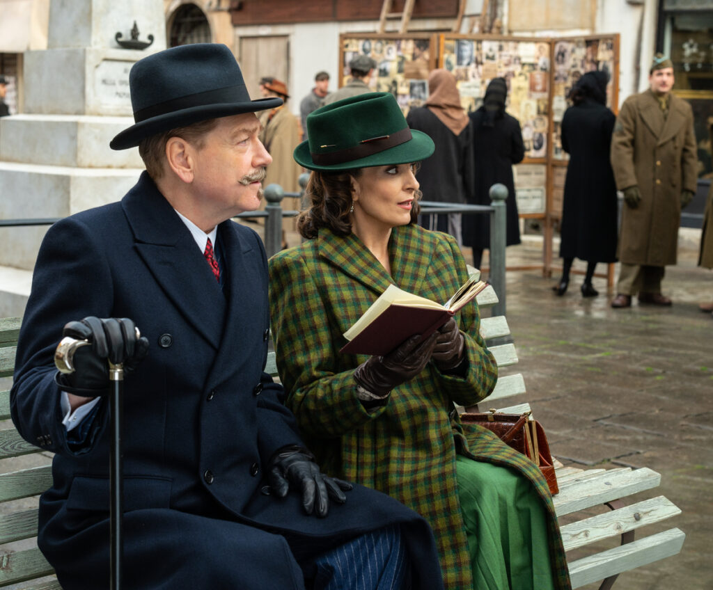 (L-R): Kenneth Branagh as Hercule Poirot and Tina Fey as Ariadne Oliver in 20th Century Studios' A HAUNTING IN VENICE. Photo by Rob Youngson. © 2023 20th Century Studios. All Rights Reserved.
