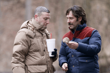 Tim Robinson and Paul Rudd examine a mushroom in the woods in FRIENDSHIP (2025)
