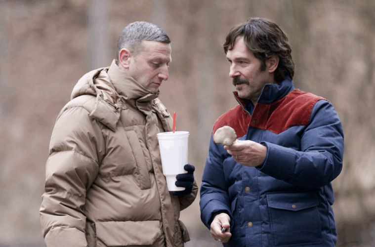 Tim Robinson and Paul Rudd examine a mushroom in the woods in FRIENDSHIP (2025)