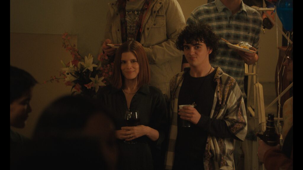 Kate Mara and Jack Dylan Grazer attend a party in FRIENDSHIP (2025)