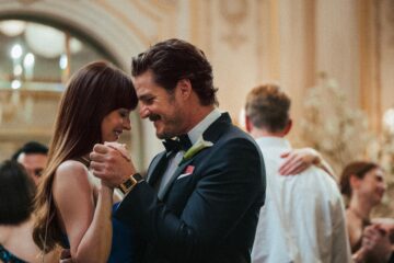 Dakota Johnson and Pedro Pascal dance at a wedding in MATERIALISTS (2025)