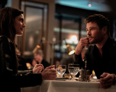 Monica Barbaro and Chris Hemworth eat dinner in CRIME 101 (2026)