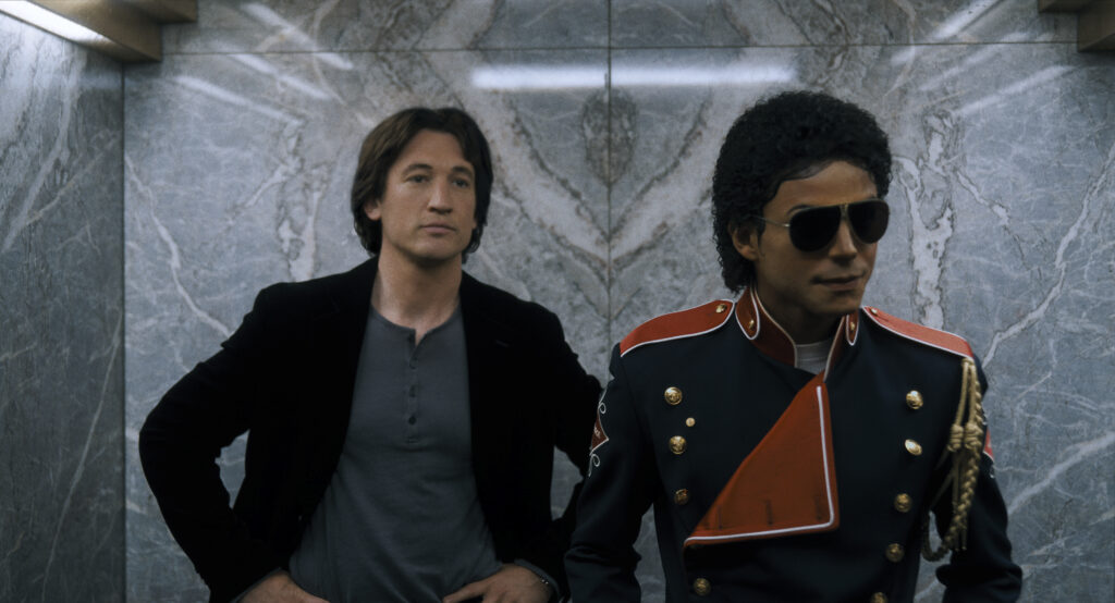 Miles Teller as John Branca and Jaafar Jackson as Michael Jackson in Michael. Photo Credit: Courtesy of Lionsgate