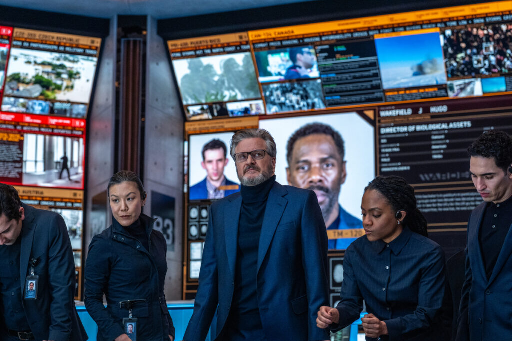 Colin Firth (center, standing) in DISCLOSURE DAY, directed by Steven Spielberg.